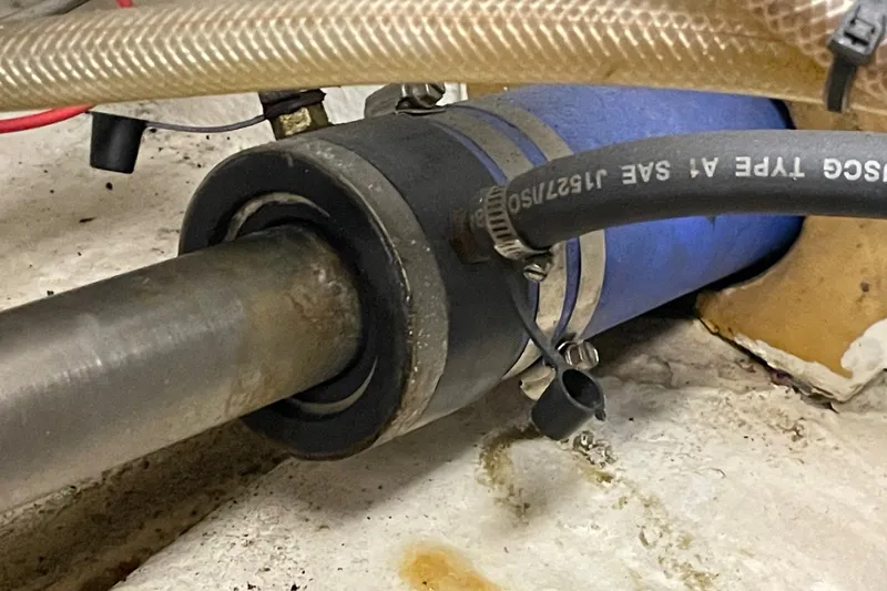 Close-up of a 1975 Uniflite Sport Fisher 42 boat's shaft and hose connections.