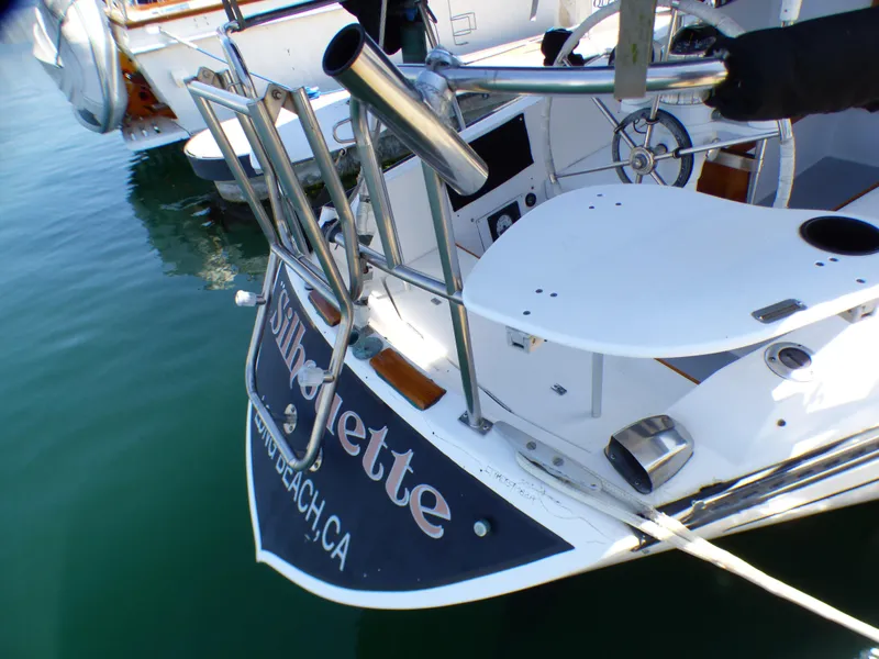 Catalina 38 sailboat, 1982 model, docked with visible stern and equipment.