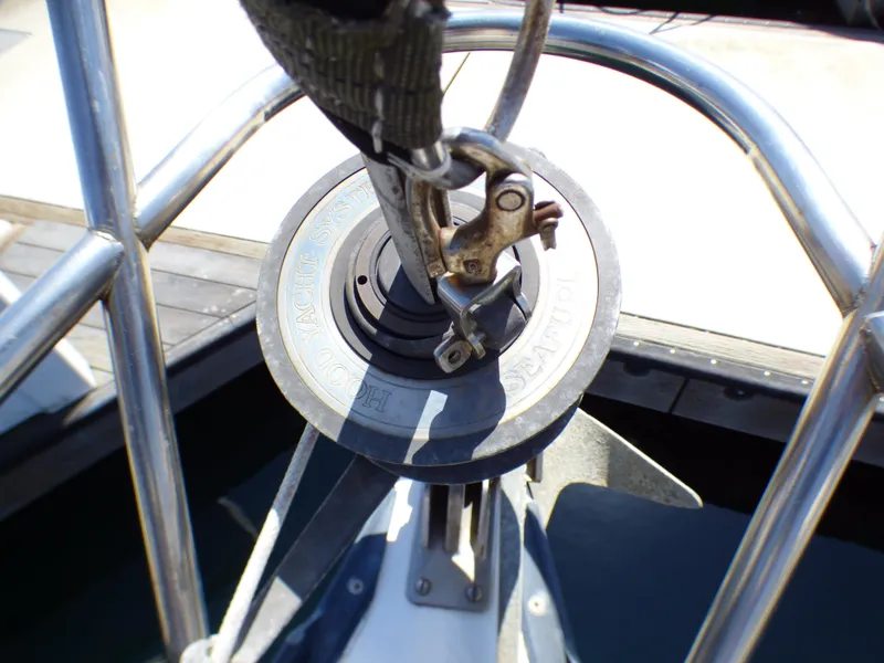 Close-up of a Catalina 38 sailboat's deck hardware, featuring a winch and railing, 1982 model.