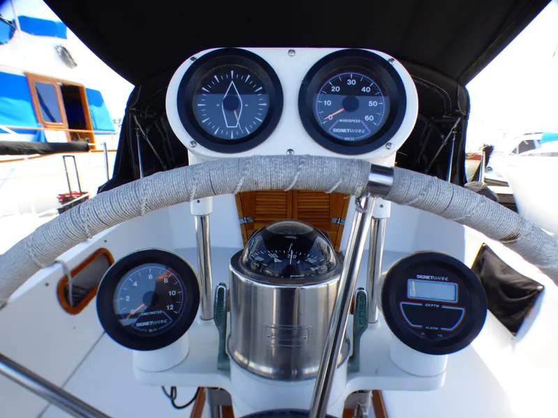 Cockpit of 1982 Catalina 38 sailboat with navigation instruments and steering wheel.