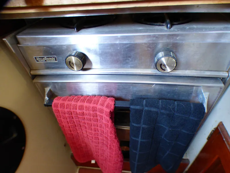 Stainless steel boat stove with red and blue towels, Catalina 38, 1982 model.