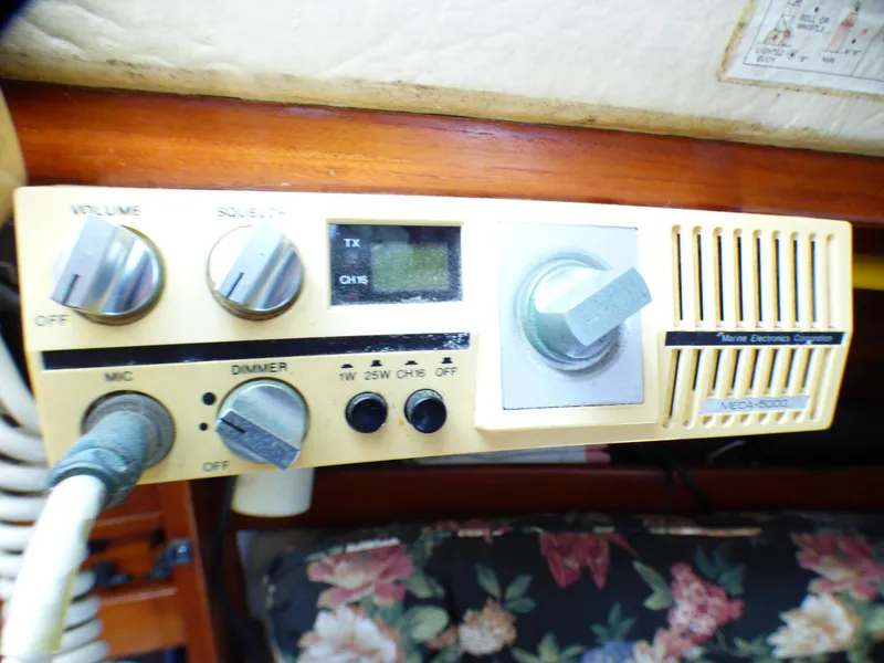 Marine radio equipment on a 1982 Catalina 38 sailboat, featuring various control knobs.