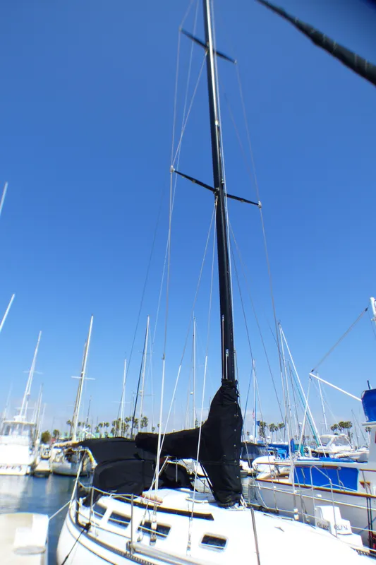 1982 Catalina 38 sailboat docked in marina under clear blue sky.