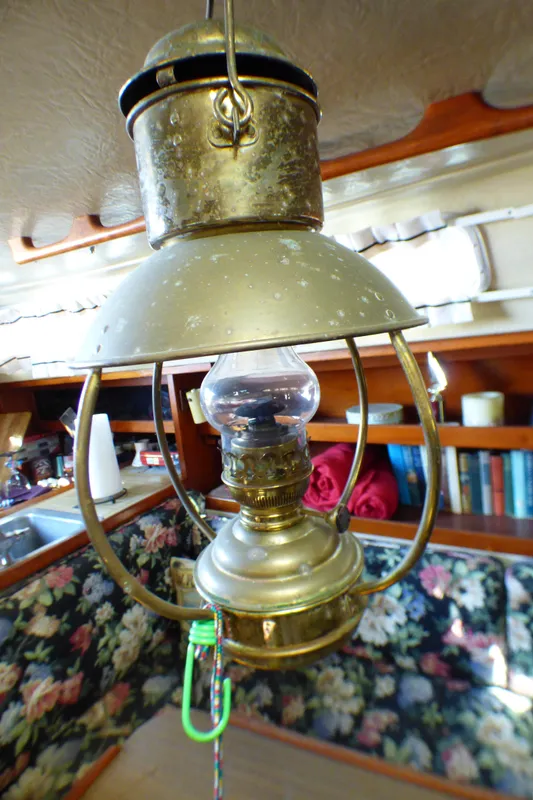 Vintage brass lantern inside a 1982 Catalina 38 sailboat cabin.
