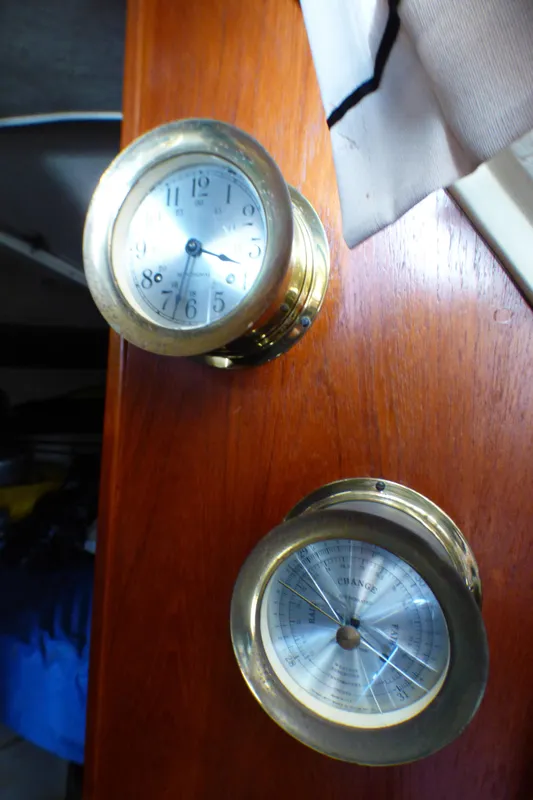 Brass clock and barometer on 1982 Catalina 38 sailboat interior.