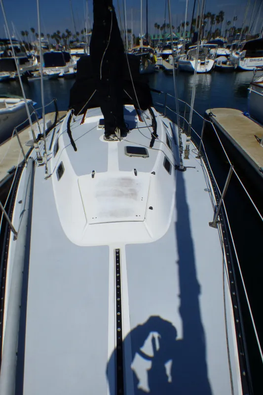 1982 Catalina 38 sailboat deck view in marina setting.