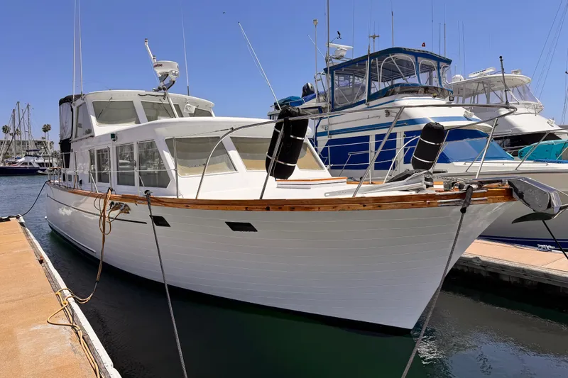 1978 Roughwater 41 yacht docked at marina under clear blue sky.