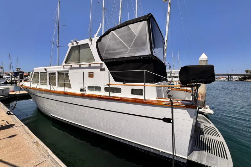 1978 Roughwater 41 yacht docked at marina under clear blue sky.