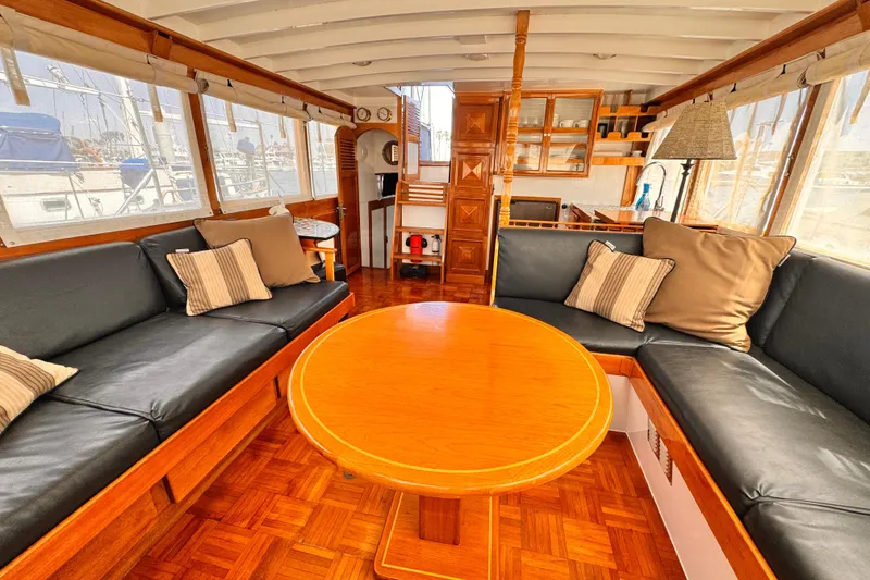 Interior of 1978 Roughwater 41 boat with wooden furnishings and cozy seating area.
