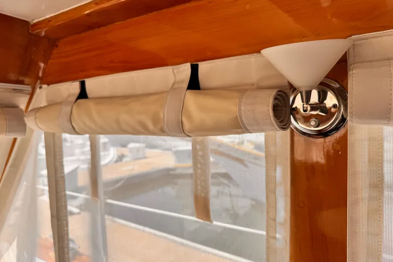 1978 Roughwater 41 interior with rolled curtains and wooden trim.