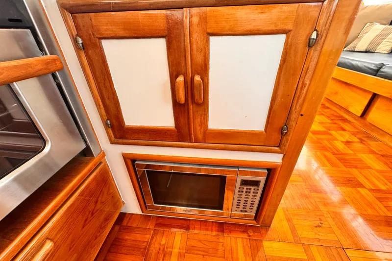 Wooden cabinetry with microwave in 1978 Roughwater 41 boat interior.