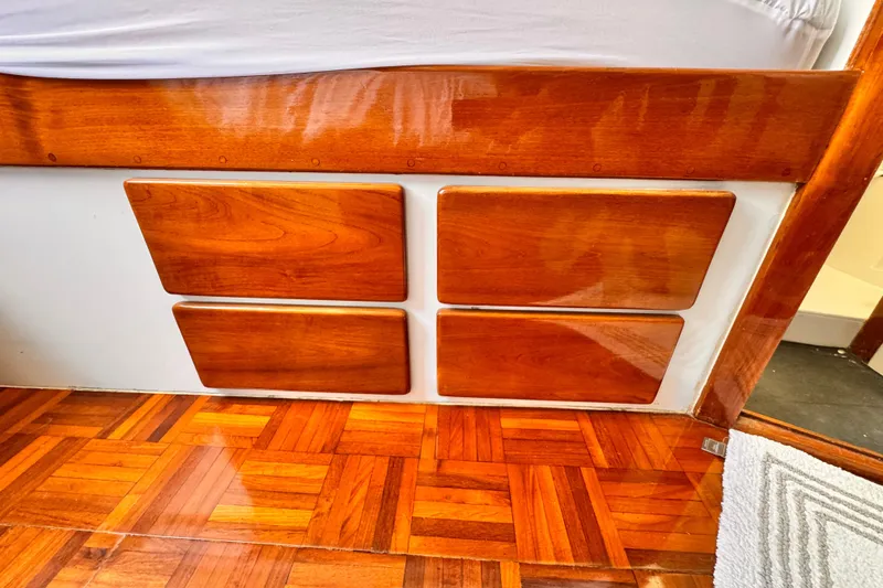 Polished wooden interior of a 1978 Roughwater 41 boat, featuring parquet flooring.