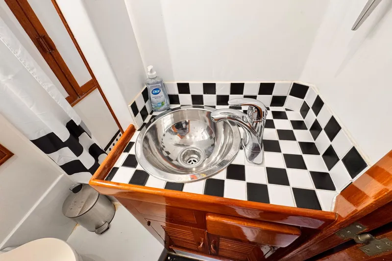 1978 Roughwater 41 bathroom sink with checkered tiles and chrome faucet.