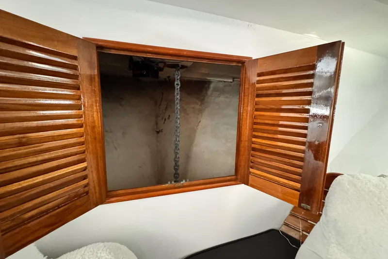 Wooden cabinet with open doors revealing a chain inside, Roughwater 41, 1978 model.