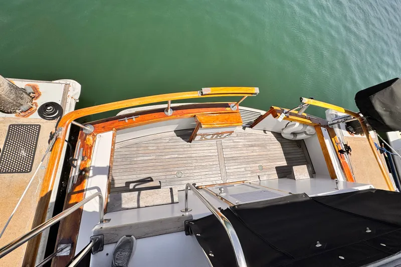 Stern view of 1978 Roughwater 41 boat with wooden deck and railing.