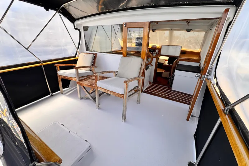 1978 Roughwater 41 boat interior with wooden chairs and helm station.