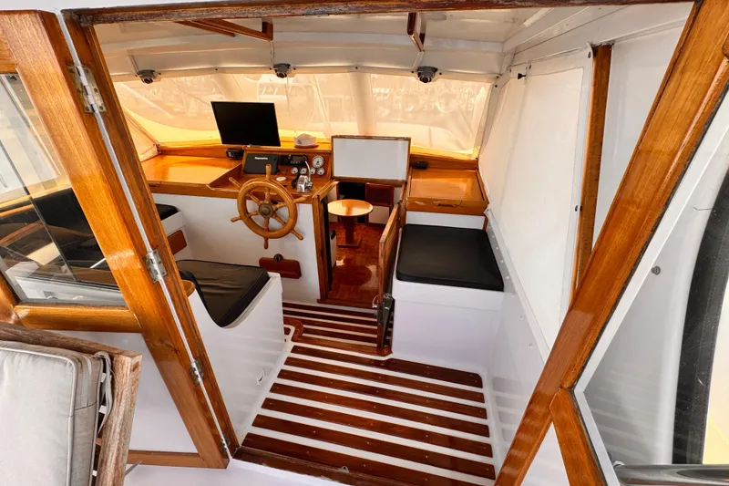 Interior of a 1978 Roughwater 41 boat with wooden accents and steering wheel.