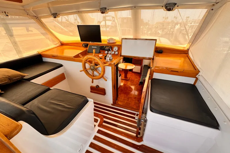 1978 Roughwater 41 boat interior with wooden helm, black seating, and nautical instruments.