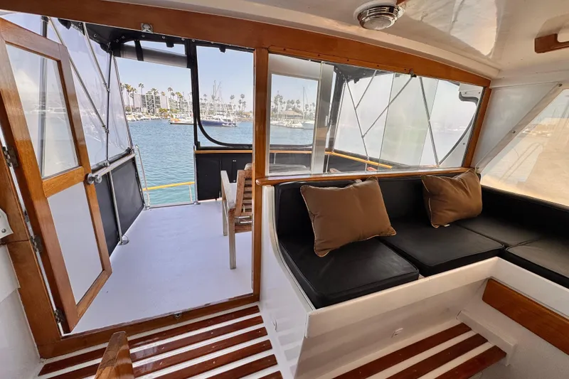 Interior of 1978 Roughwater 41 boat with seating and marina view.
