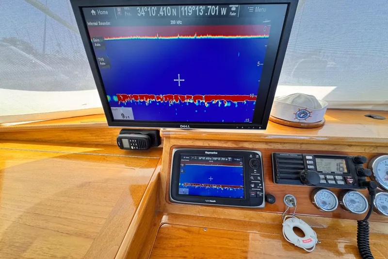 Boat dashboard with sonar display, Roughwater 41, 1978 model, showing depth and navigation instruments.