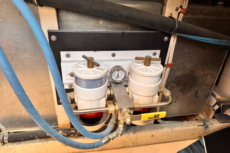Diesel fuel filter system in a 1978 Roughwater 41 boat engine compartment.