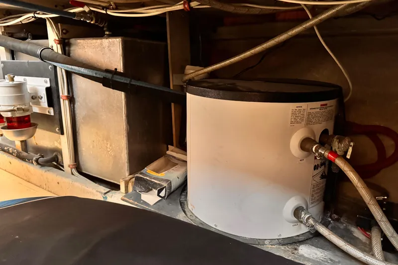 Engine room of a 1978 Roughwater 41 boat, featuring a water heater and fuel filter system.
