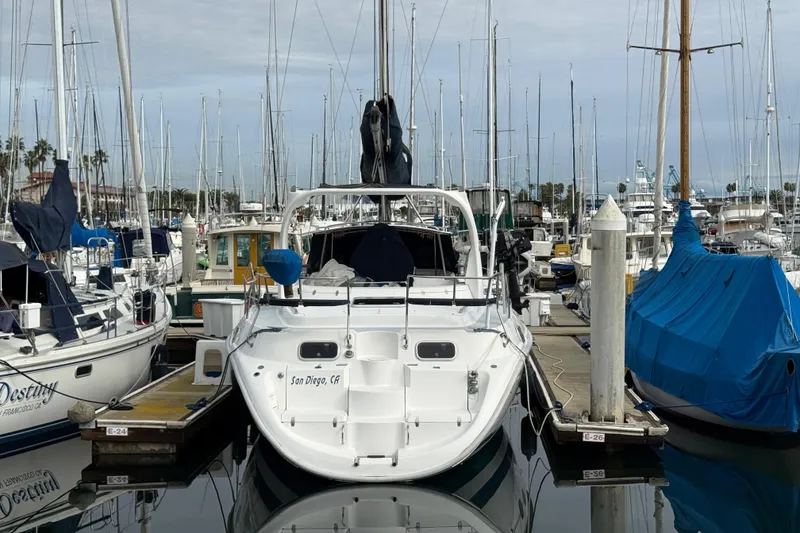 Hunter Passage 420 sailboat docked in San Diego marina, surrounded by other boats.
