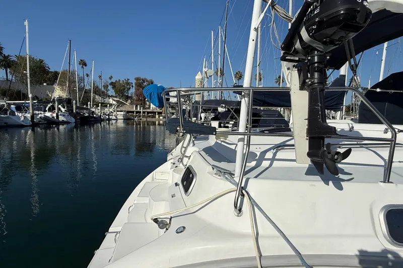 1999 Hunter Passage 420 sailboat docked in a marina with clear blue skies.