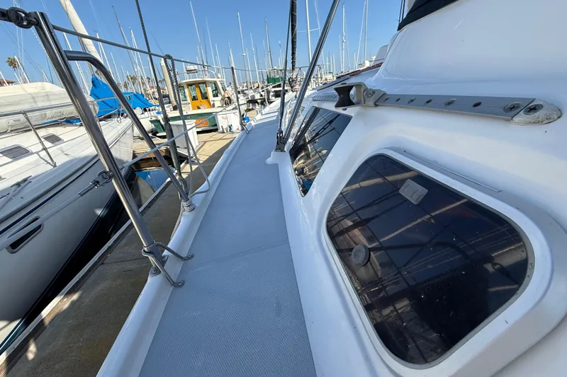 1999 Hunter Passage 420 sailboat deck view at marina, showcasing sleek design and windows.