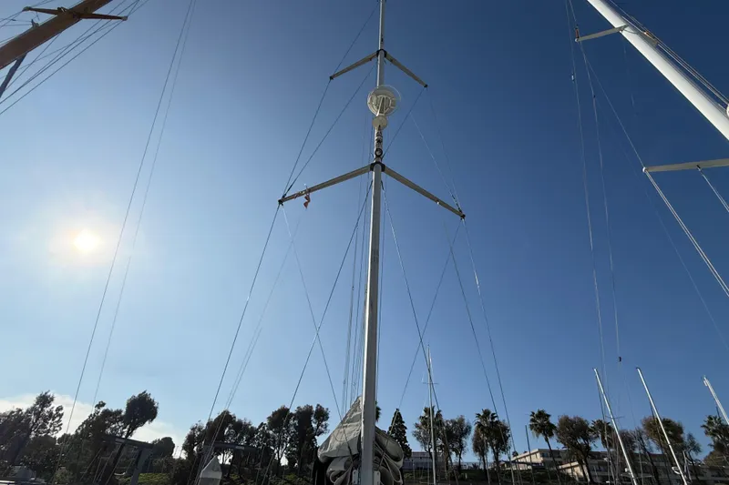 Sailboat mast of 1999 Hunter Passage 420 against clear blue sky.