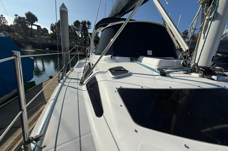 1999 Hunter Passage 420 sailboat docked at marina, side view with rigging details.