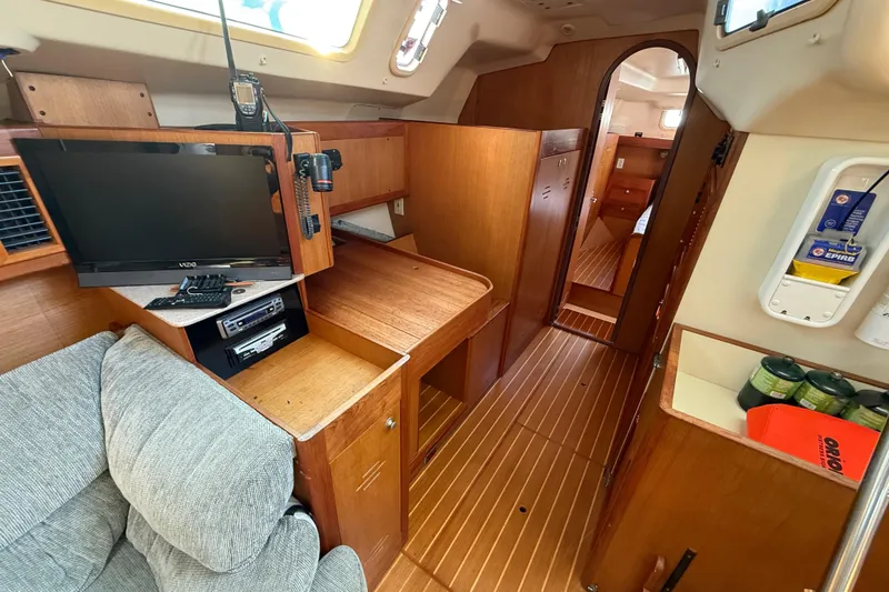 Interior of 1999 Hunter Passage 420 sailboat with wood finish and modern amenities.