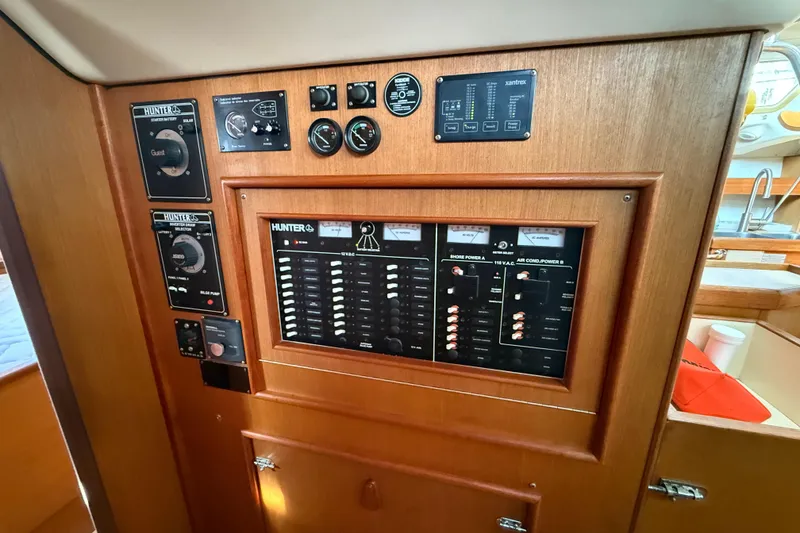Control panel of 1999 Hunter Passage 420 sailboat with various gauges and switches.