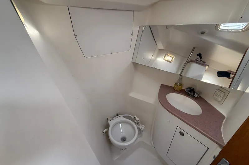 Bathroom interior of 1999 Hunter Passage 420 yacht, featuring sink and mirror.