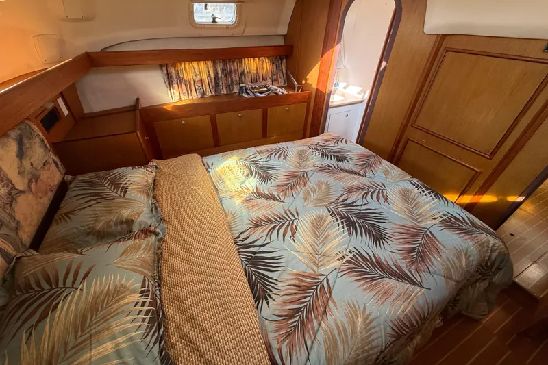 Cozy cabin interior of 1999 Hunter Passage 420 sailboat with tropical bedding.