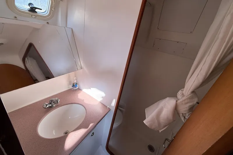 Bathroom interior of 1999 Hunter Passage 420 yacht with sink and shower.