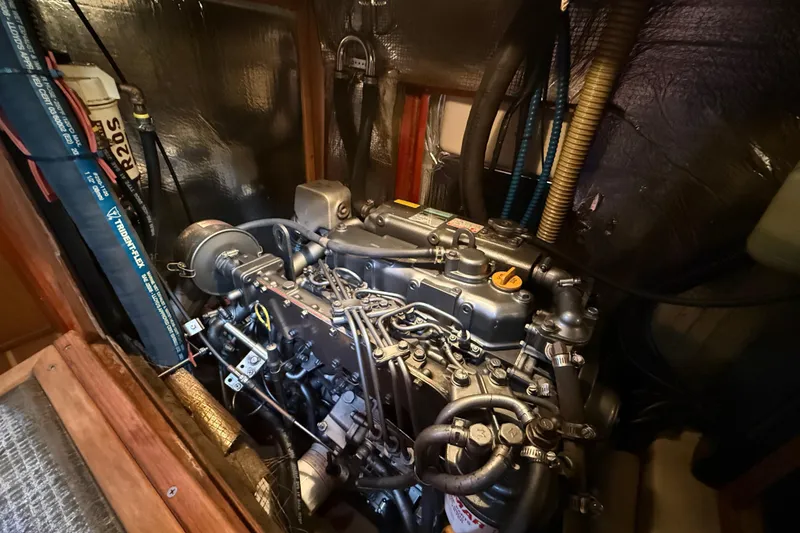 Engine compartment of a 1999 Hunter Passage 420 sailboat, showcasing detailed mechanical components.