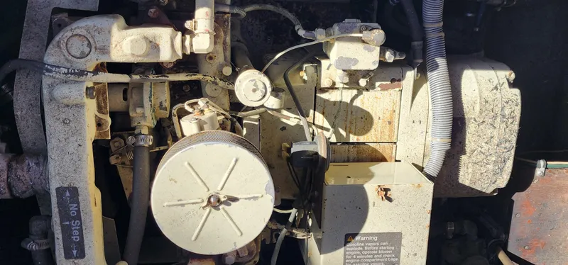 Engine components of a 1985 Bertram 33 Flybridge Cruiser in close-up view.