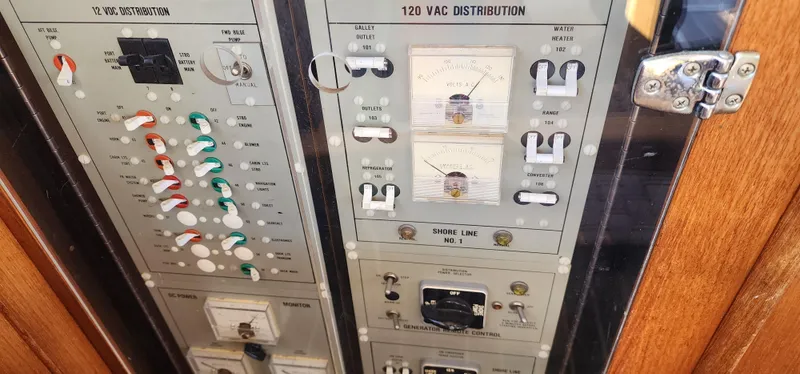 Electrical panel of 1985 Bertram 33 Flybridge Cruiser with switches and gauges.
