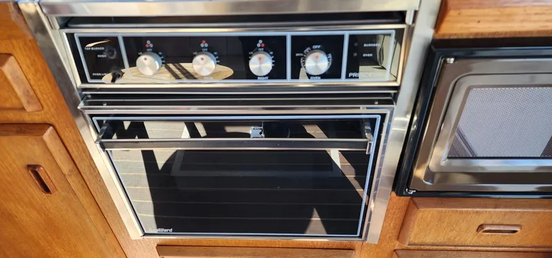 Built-in oven and microwave in a 1985 Bertram 33 Flybridge Cruiser kitchen.