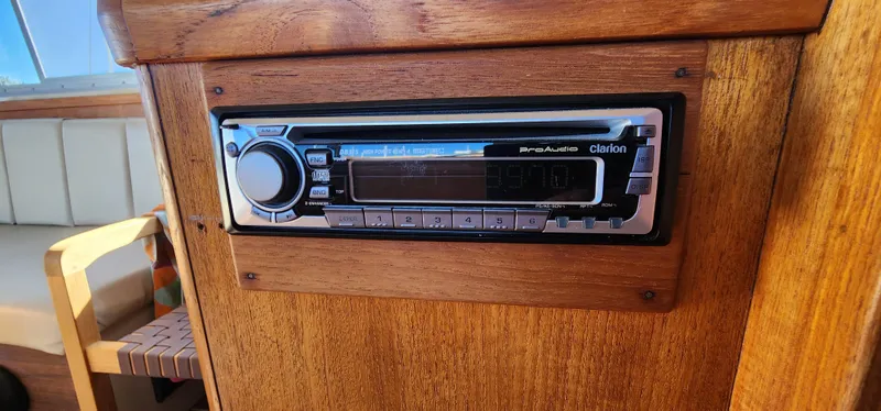 Built-in stereo system on 1985 Bertram 33 Flybridge Cruiser, wooden interior detail.
