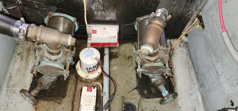 Engine room of a 1985 Bertram 33 Flybridge Cruiser showing mechanical components and wiring.