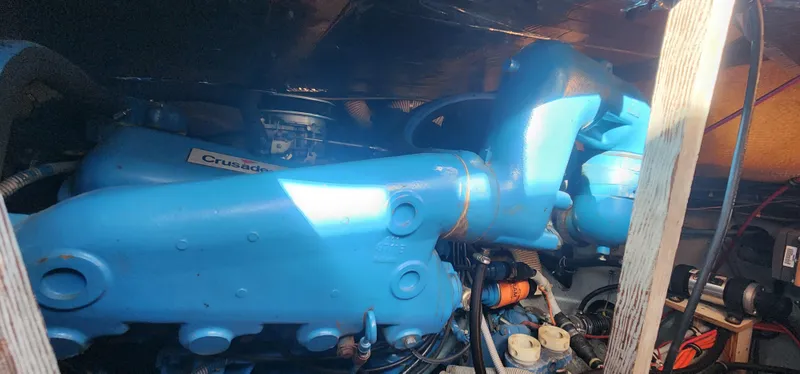 Engine compartment of a 1985 Bertram 33 Flybridge Cruiser with blue components.