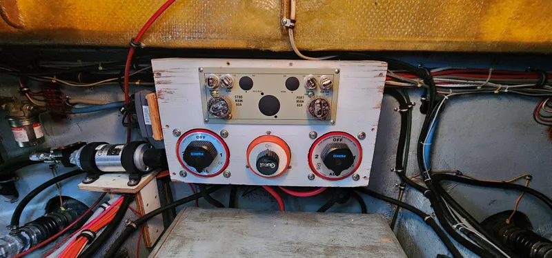 Electrical panel of a 1985 Bertram 33 Flybridge Cruiser with wiring and controls.