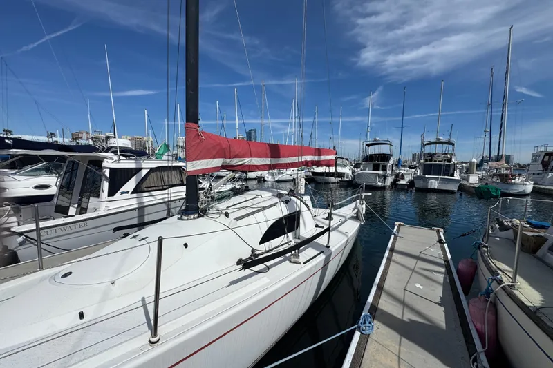 Sailboat Flying Tiger 10M, 2007 model, docked in a marina under a clear blue sky.
