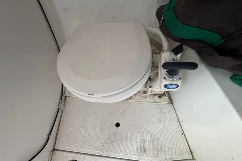 Boat toilet in a 2007 Flying Tiger 10M, featuring a manual pump handle.