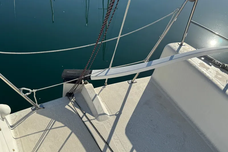 Sailboat deck of 2007 Flying Tiger 10M, with ropes and calm water reflection.