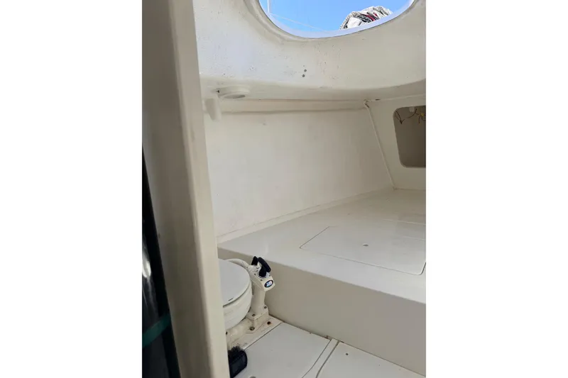 Interior of a 2007 Flying Tiger 10M sailboat, featuring a compact marine toilet.