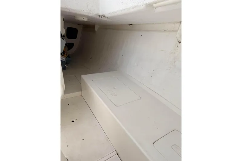 Interior of a 2007 Flying Tiger 10M sailboat, featuring a minimalist white cabin design.