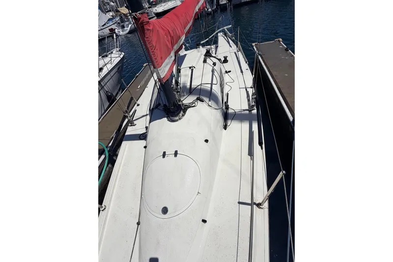 Sailboat docked at marina, Flying Tiger 10M, 2007 model, with red sail cover.